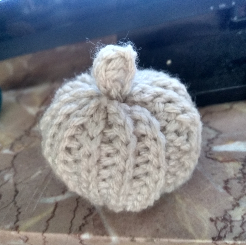 Beige crocheted pumpkin.